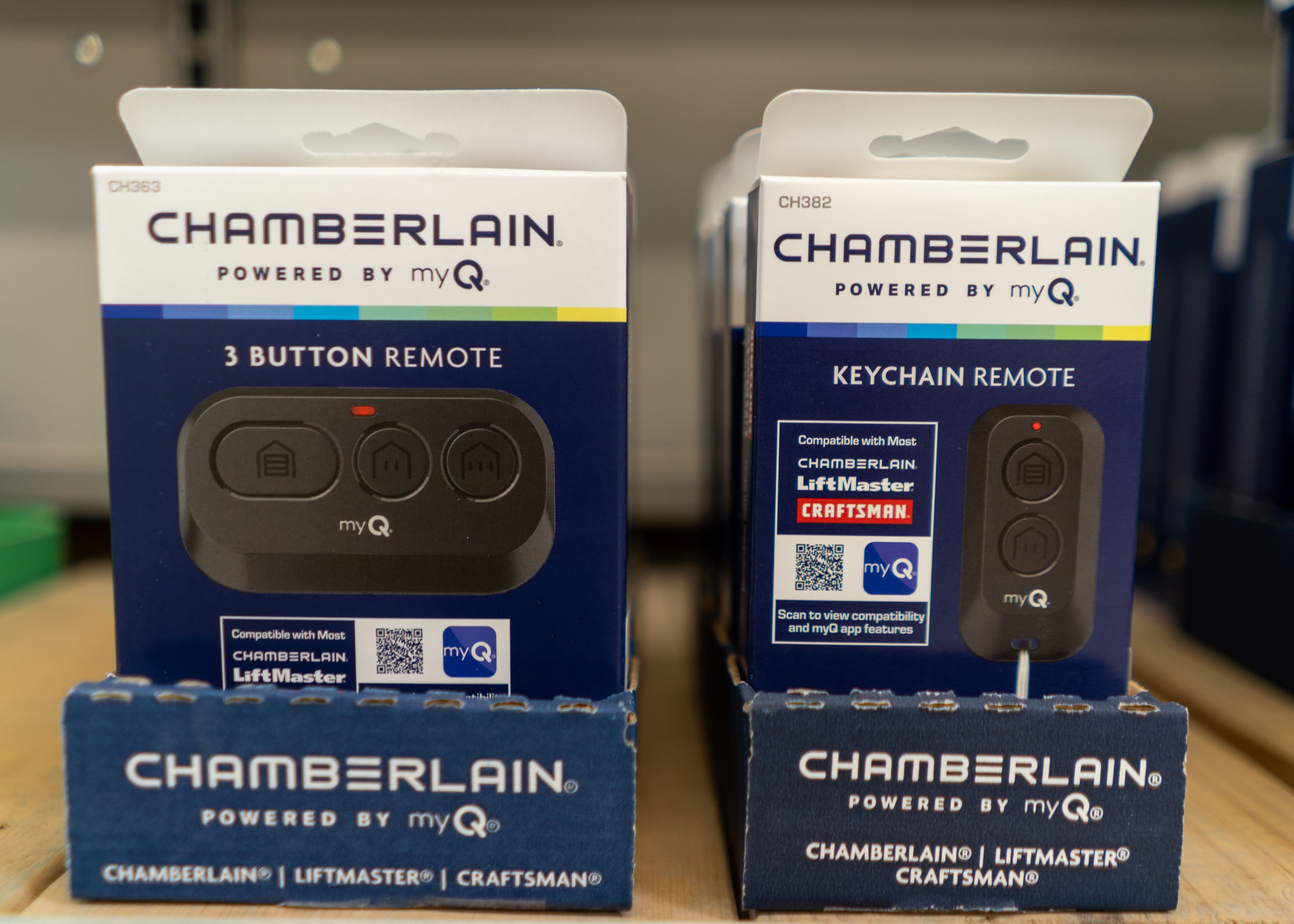 Chamberlain 3 Button and Keychain Remotes for garage door openers on store shelf.